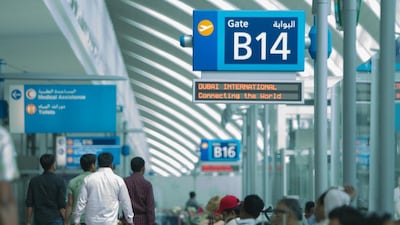 Passengers wait and walk through Terminal 3 at Dubai International Airport. National Geographic Channels / Andy Davis
