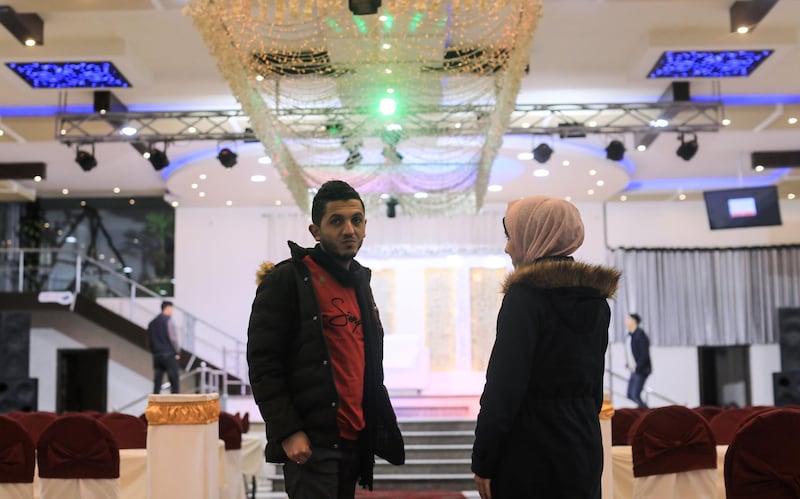 Palestinian groom Ahmed al-ketnani, 27, and his fiancee Sara, 19, stand at the wedding hall where their marriage ceremony was due to take place, after they have decided to postpone it amids a coronavirus pandemic in Gaza City.  AFP