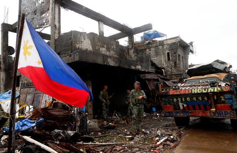 epa06270785 Filipino soldiers rest inside a damaged building in the ruined city of Marawi, southern Philippines, 17 October 2017. The President of the Philippines Rodrigo Duterte declared the city of Marawi is liberated after five months of fighting between the Philippine armed forces and rebels allied to the Islamic State terror group. Rodrigo Duterte's announcement came a day after the army killed Isnilon Hapilon, the self-proclaimed emir of the IS in Southeast Asia and leader of the Islamist rebels in southern Philippines.  EPA/JOEFFREY MAITEM