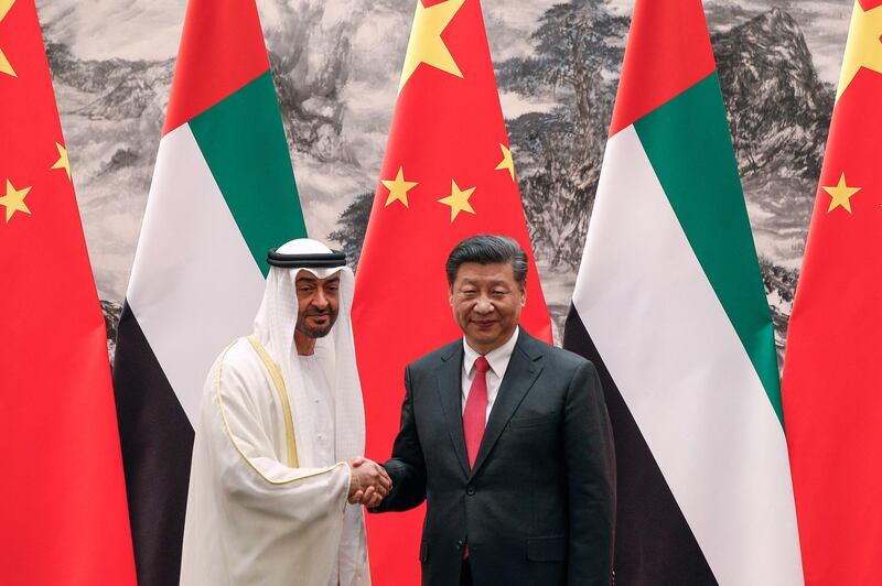 Sheikh Mohamed bin Zayed shakes hands with Mr Xi after witnessing an agreement signing ceremony at the Great Hall of the People. Andy Wong / Getty