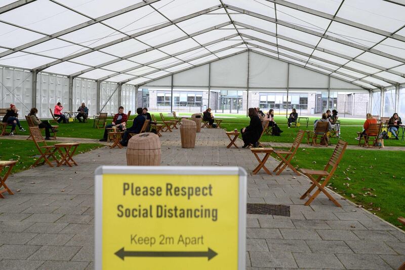 Students maintain social distancing in a large marquee erected by the university to create an additional socially distanced rest area at the University of Bolton, in Bolton. Oli Scarff / AFP