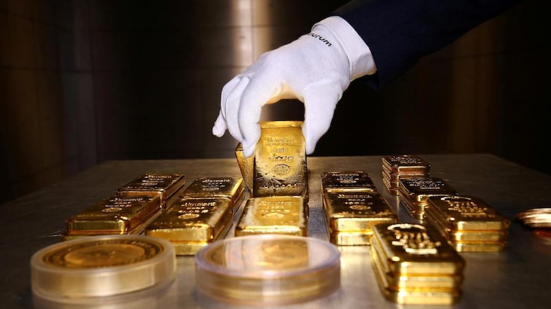 Gold bars and coins are stacked in the safe deposit boxes room of the Pro Aurum gold house in Munich, Germany. Gold closed at $1,951.35 an ounce on Friday, up 3.6 per cent over the course of last week - it's highest weekly gain since July. Reuters