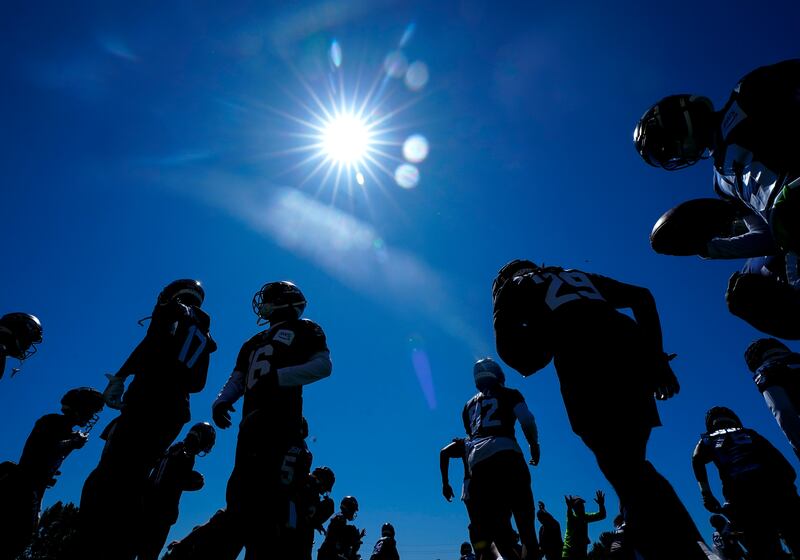 Members of the Seattle Seahawks warm up during the NFL football team's training camp in Renton, Washington State. AP