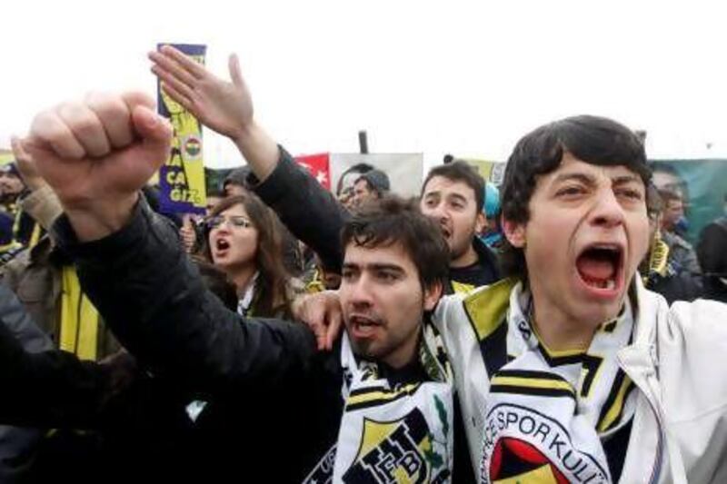 Fenerbahce fans shout slogans of support for their club chairman, Aziz Yildirim, outside the heavily guarded Silivri prison, 70km east of Istanbul, where the trial of 93 suspects accused of fixing football matches is taking place.