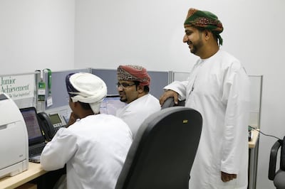 Shabib Al Maamari, pictured standing, started the non-profit organisation Injaz Oman to inspire students to join the private sector and help them to receive relevant training. Justin Vela/The National