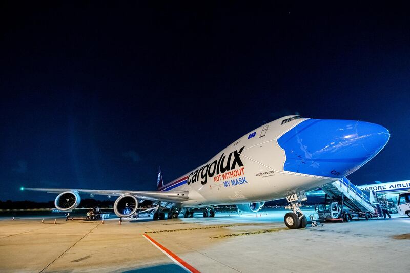 A plane of Luxembourg's Cargolux cargo airline reading ''Not without my mask'' on its body is seen at the Changi Airport, amid the outbreak of the coronavirus disease (COVID-19), in Singapore, August 27, 2020. Picture taken August 27, 2020. Changi Airport Group/Handout via REUTERS  THIS IMAGE HAS BEEN SUPPLIED BY A THIRD PARTY. NO RESALES. NO ARCHIVES