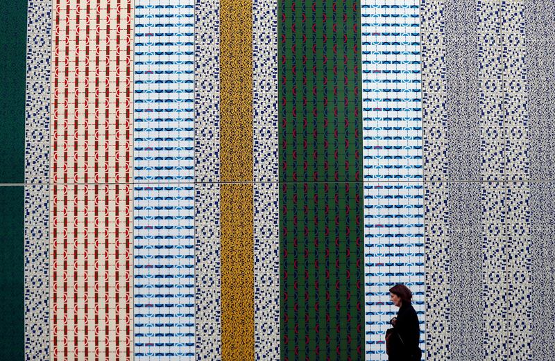 A woman walks in Chapel Street in London, Britain. Reuters