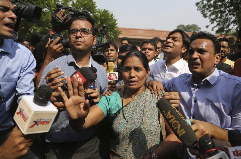 Asha Devi, the mother of the victim of the fatal 2012 gang rape on a bus, appears outside the supreme court in New Delhi, India, after upheld the death penalty for four men convicted in the fatal assault. Friday, May 5, 2017. Altaf Qadri / AP