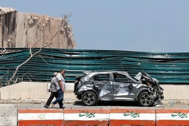 Men walk near site of the blast in Beirut's port area, Lebanon on August 8, 2020. REUTERS