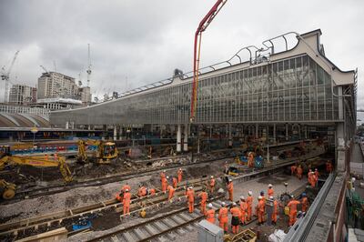 Construction workers build new track during renovation works aiming at boosting peak-time capacity 30 percent at London Waterloo train station in London, U.K., on Monday, Aug. 7, 2017. The 800 million-pound ($1 billion) renovation at Waterloo, which will open four platforms mothballed since Channel Tunnel express trains switched to St. Pancras station and extend four more, should deliver a service boost matching the London Bridge project but without the upheaval, Stagecoach Group Plc Chief Executive Officer Martin Griffiths said in July. Photographer: Simon Dawson/Bloomberg