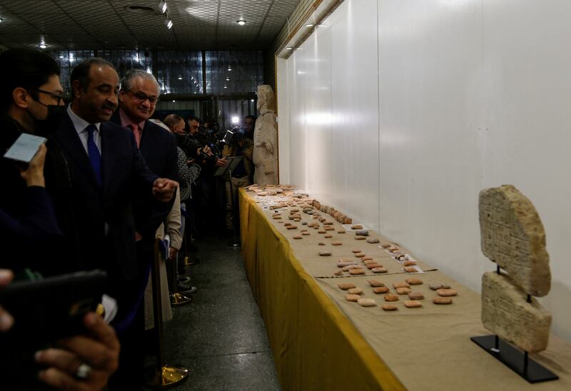 Iraqi Culture Minister Hassan Nadhim looks at ancient artefacts handed over by Lebanon to Iraq on display at the National Museum in Baghdad on February 8, 2022. Reuters