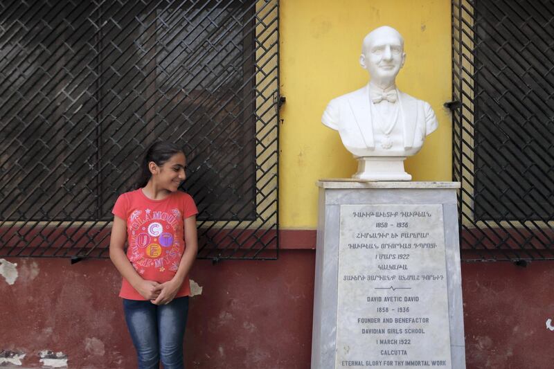 A pupil with a bust of one of the founders of the school. Courtesy Jenny Gustafsson