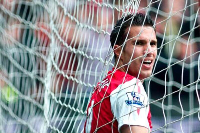 FILE - Arsenal's Robin van Persie reacts after missing a shot against Norwich City, during their English Premier League soccer match at Emirates stadium in London, in this Saturday, May 5 file photo, 2012. Manchester United says Wednesday Aug 15 2012 the club has reached an agreement with Premier League rival Arsenal to buy Netherlands striker Robin van Persie.United says Van Persie is yet to agree to personal terms, with the deal subject to a medical examination. No financial details were disclosed, although British media has reported that Arsenal wanted 20 million pounds ($31.3 million) for its captain, who has one year left on his contract. (AP Photo/Bogdan Maran, File) *** Local Caption ***  Britain Soccer  Man United Van Persie.JPEG-010e1.jpg