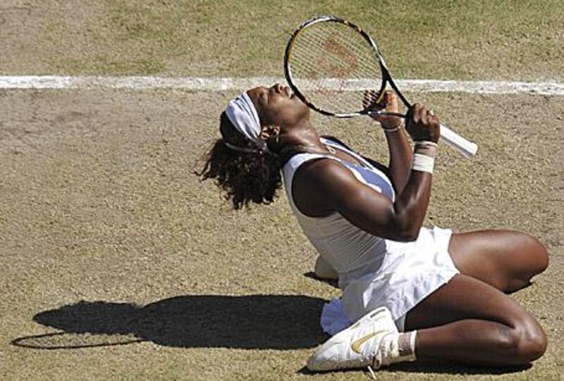 Serena Williams falls to the ground after beating her sister Venus on Centre Court.