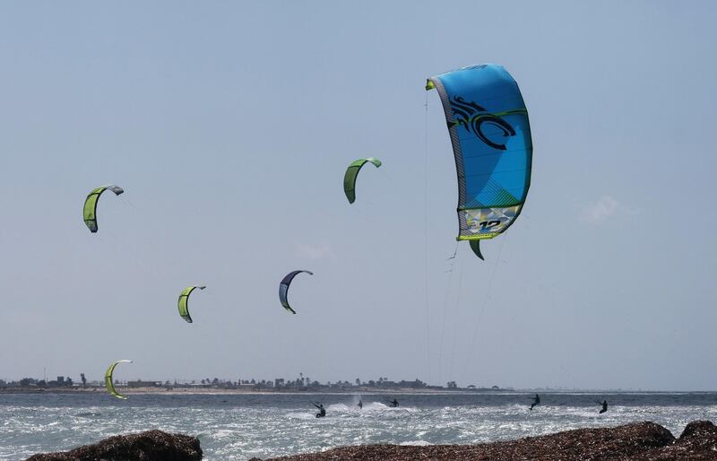 Kite surfers enjoy strong winds in Benghazi, Libya. Reuters