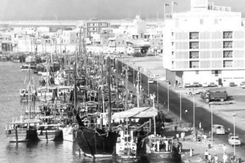 The 1971 image of the Dubai creek, crowded with dhows. At right is The National Bank of Dubai.