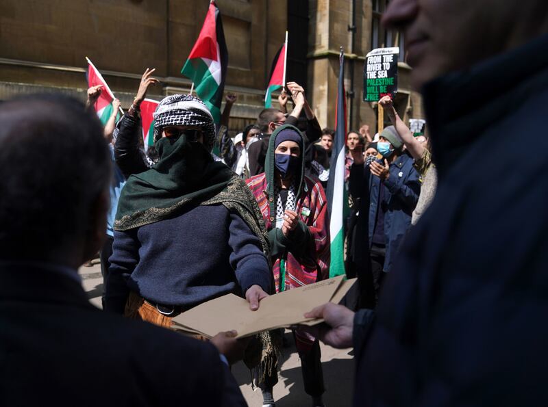 Demands are delivered to the university for vice chancellor Deborah Prentice, during a student march through the grounds of Cambridge University. PA