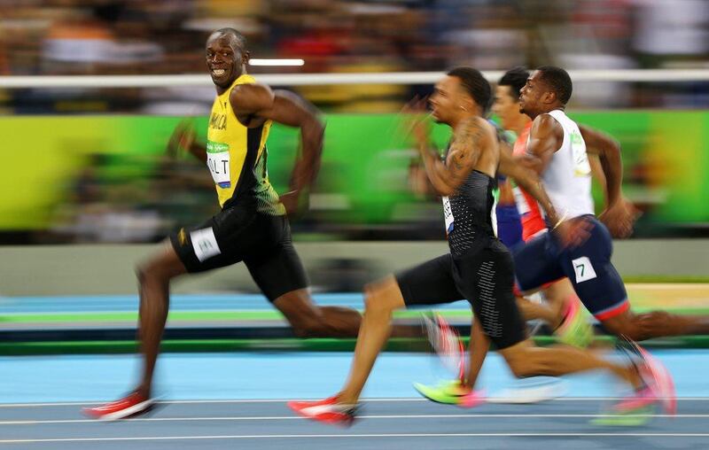 Usain Bolt smiles for the camera as he crosses the finish line to win the men's 100m final at the 2016 Rio Olympics on Sunday. Kai Pfaffenbach / Reuters / August 14, 2016 