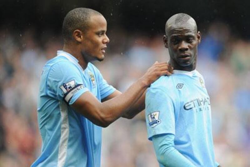 Vincent Kompany, left, talks with Mario Balotelli after the Italy striker had put Manchester City 1-0 up against Everton.