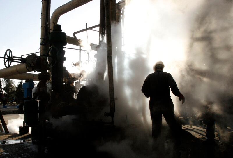A worker repairs part of a unit of the Tehran oil refinery in a photo taken in 2007. AP