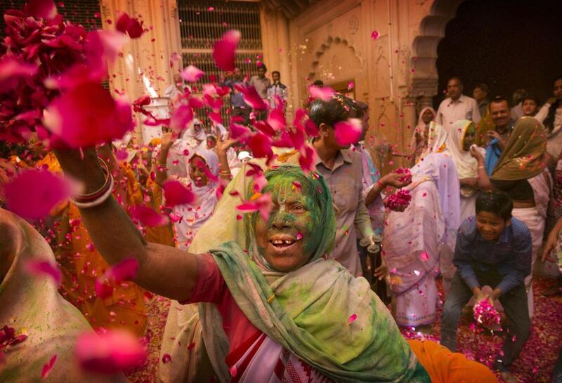 Indian Hindu widows throw flower petals and colored powder during Holi celebrations at the Gopinath temple, India. A few years ago this joyful celebration was forbidden for Hindu widows. Like hundreds of thousands of observant Hindu women they would have been expected to live out their days in quiet worship, dressed only in white, their very presence being considered inauspicious for all religious festivities. Manish Swarup / AP