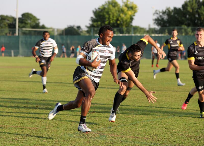 Panapasa Qeruqeru Nasove of LAR Speranza 22 (black and white) take on Zastawa on the first day of the Emirates Dubai Sevens. Chris Whiteoak / The National