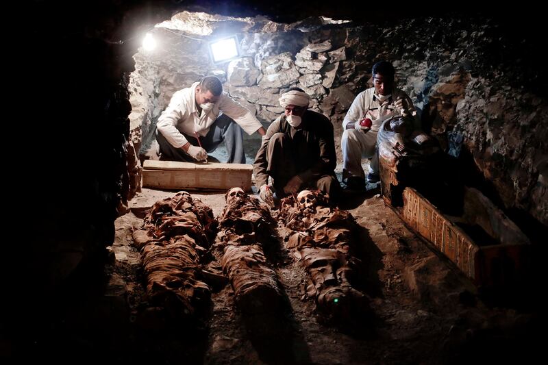 Archaeologists work on mummies found in the New Kingdom tomb belonging to a royal goldsmith in Luxor, Egypt. Nariman El-Mofty / AP Photo