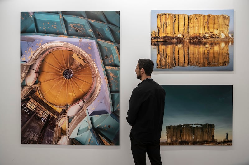 Photographer Dia Mrad at the Zawyeh Gallery booth where his works are on view.