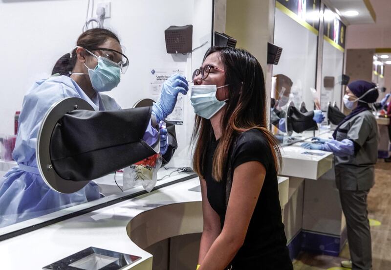 Abu Dhabi, United Arab Emirates, May 6, 2020. the new Ambulatory Healthcare Services, a SEHA Health System Facility, National Screening Project in Mussafah Industrial Area in Abu Dhabi.  --  Jennifer Ebuen- 27, from the Philippines gets a swab test.
Victor Besa / The National
Section:  NA
Reporter:  Nick Webster