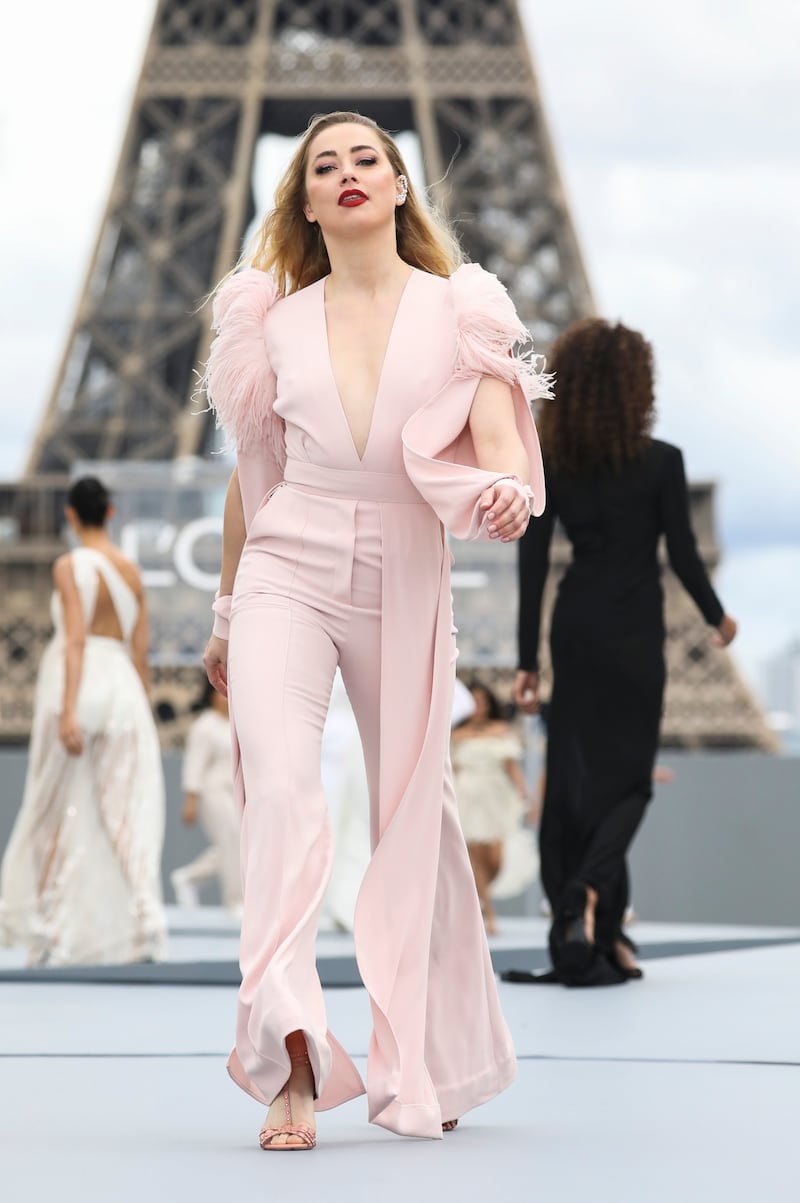 Heard wears a creation for the L'Oreal Spring/Summer 2022 fashion show presented in Paris, France, in 2021. AP