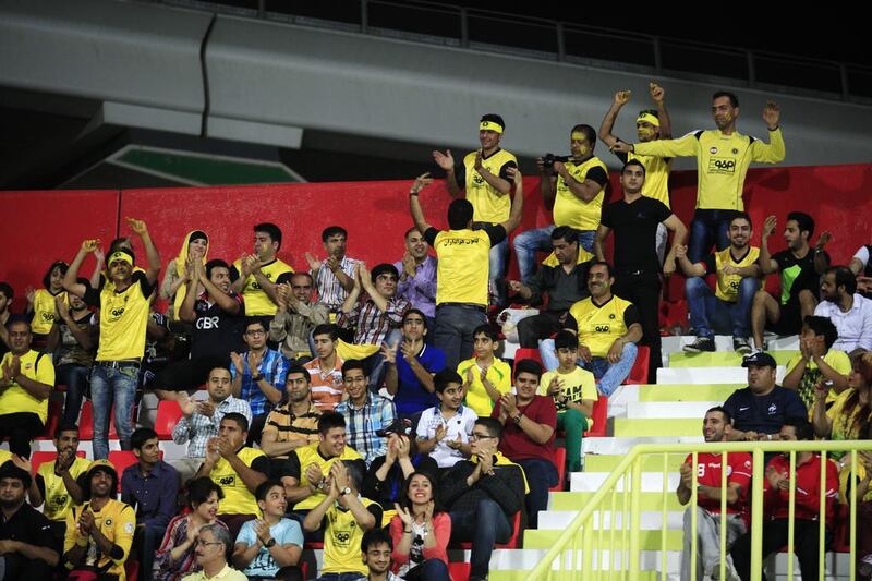 Sepahan fans cheer in Dubai during an Asian Champions League match against Al Ahli in 2014. (Sarah Dea/The National)