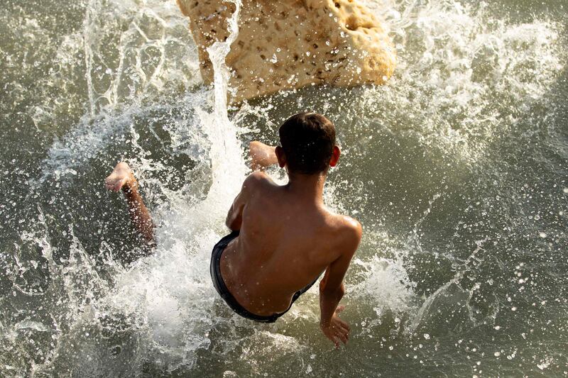 A boy dives into the waters of the Shatt Al Arab waterway.