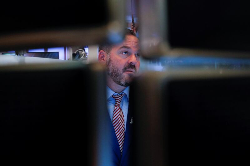 A trader works on the trading floor after the closing bell at the New York Stock Exchange (NYSE) in New York City, U.S., February 21, 2020. REUTERS/Andrew Kelly