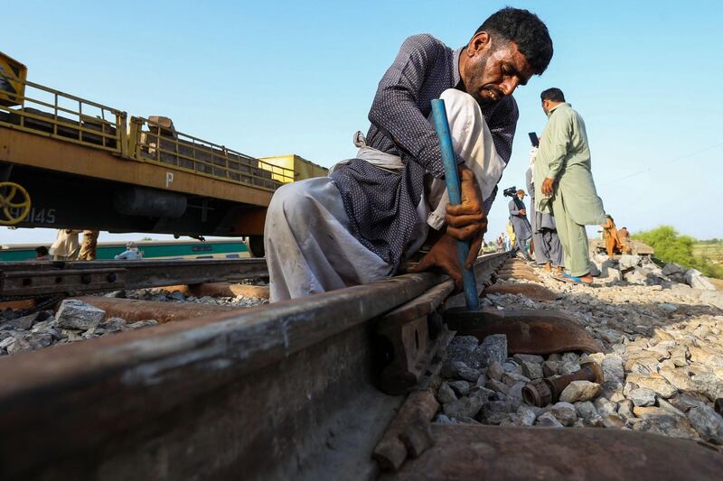 A railway worker repairs the tracks. AFP