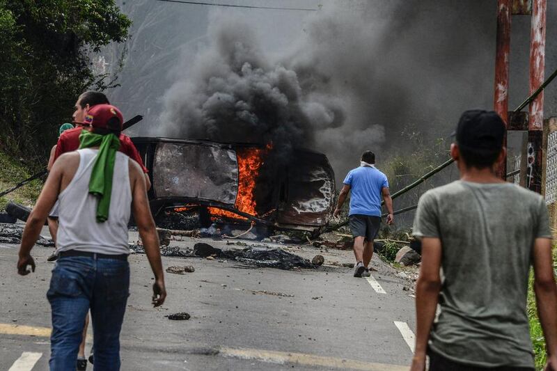 Venezuelan opposition activists set up barricades during a demonstration against President Nicolas Maduro in San Cristobal. George Castellanos / AFP Photo