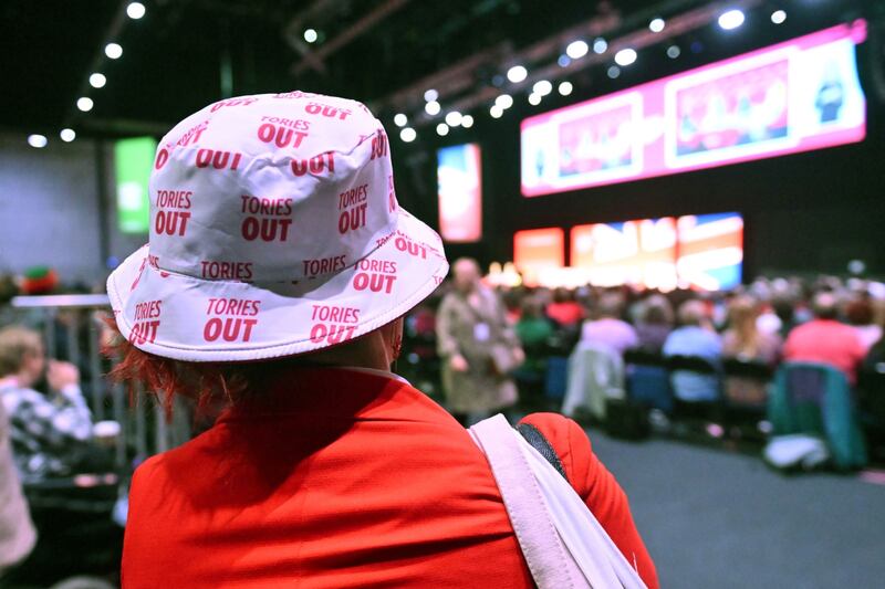 A delegate wears a hat with a slogan which reads 'Tories Out' at the Labour Party conference in Liverpool. Bloomberg