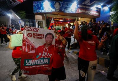 Supporters of presidential candidate Ferdinand 'Bongbong' Marcos Jr cheer outside his campaign headquarters in Mandaluyong City, Metro Manila on Monday. EPA