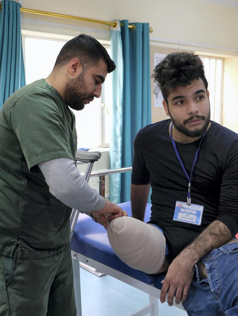 A nurse bandages Seif Salman's leg as he prepares to be measured for a prosthetic limb at a clinic run by Medicine Sans Frontiers in Baghdad. Ameer Hazim for The National