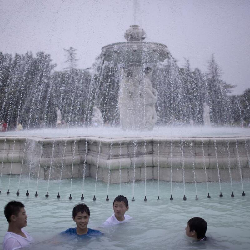 Kids play in a fountain in Beijing Beijing World Park.