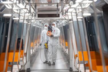 TOPSHOT - Employees of the Istanbul Municipality wearing protective gear disinfects a subway carriage to prevent the spread of the COVID-19, caused by the novel coronavirus, in Istanbul on March 12, 2020. Turkey announced on March 11, 2020 its first coronavirus case, a man who had recently travelled to Europe and is in good health. Turkey has announced several measures in recent weeks to try and stop the virus reaching the country, including thermal cameras at airports, cancelling flights to affected countries and closing its border with Iran. / AFP / Yasin AKGUL