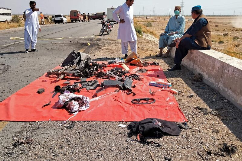Security officials examine the site after a suicide attack on a police truck in Kachhi. AFP