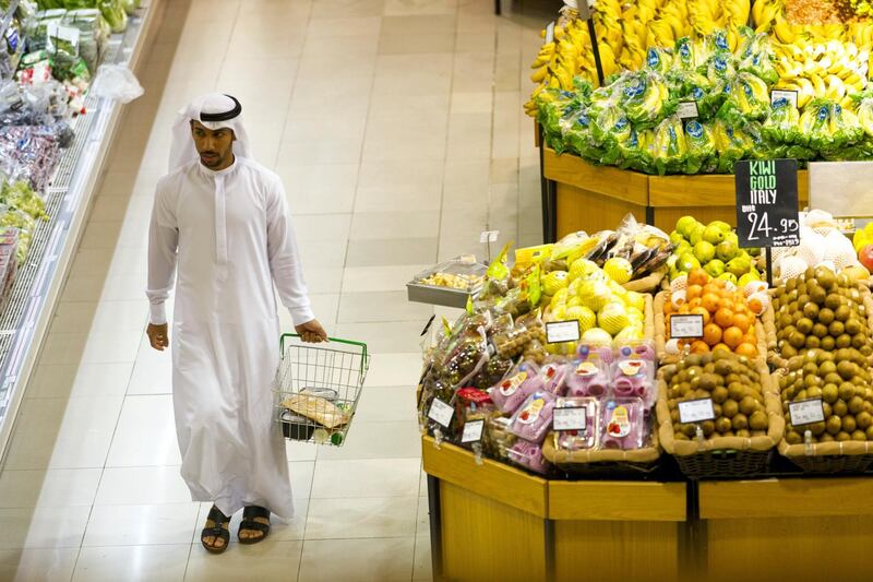 Dubai, United Arab Emirates, December 12, 2017:    An Emirati man walks through the produce section of Spinneys in the Al Karama area of Dubai on December 12, 2017. Christopher Pike / The National

Reporter: Hala Khalaf
Section: Arts & Culture