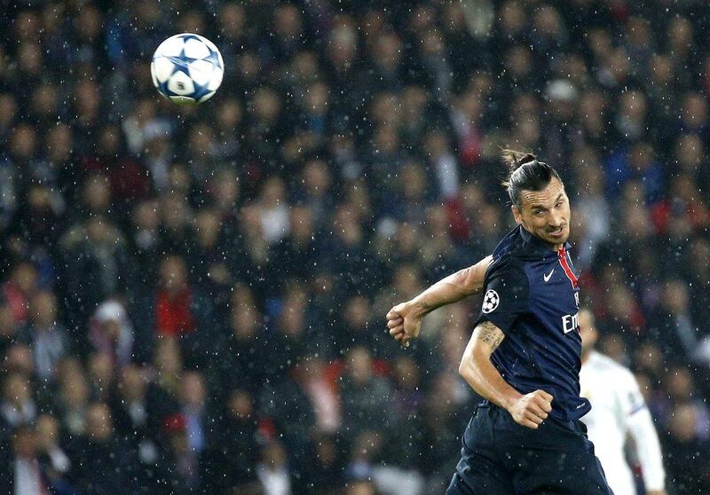 Zlatan Ibrahimovic of Paris Saint-Germain heads the ball against Real Madrid in the Champions League on Wednesday night. Yoan Valat / EPA