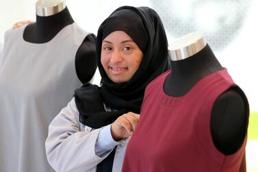 Shaima Saeed with a uniform she made for government school pupils. Chris Whiteoak / The National