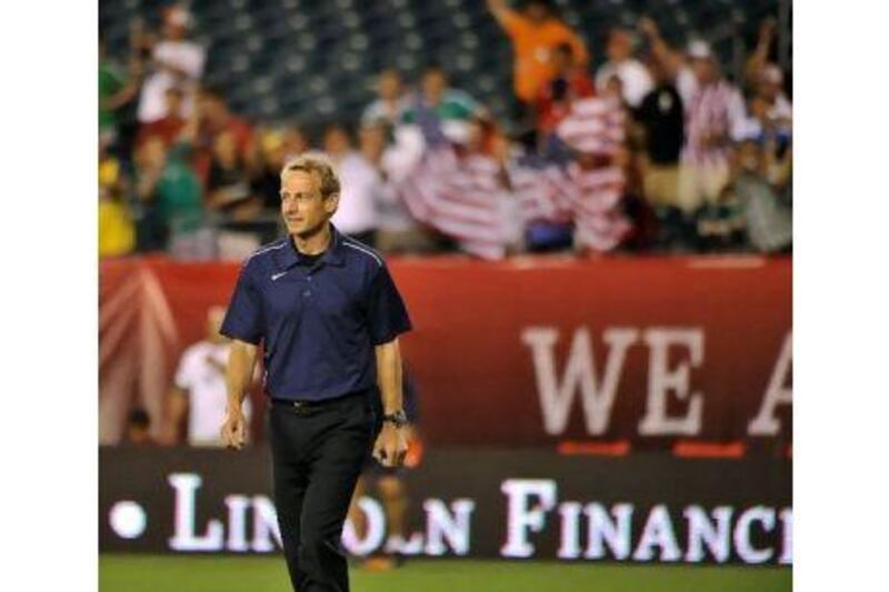 Team USA coach Jurgen Klinsmann is cheered as he walks onto the field before the start of their international friendly match against team Mexico.