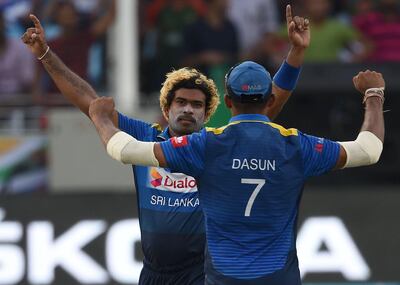 Sri Lankan cricketer Lasith Malinga (L) celebrates with teammate Dasun Shanaka after he dismissed Bangladeshi batsman Mohammad Mithun (R) during the one day international (ODI) Asia Cup cricket match between Bangladesh and Sri Lanka at the Dubai International Cricket Stadium in Dubai on September 15, 2018. / AFP / Ishara S. KODIKARA
