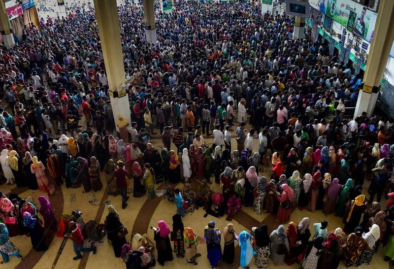 Bangladeshi travellers queue to collect tickets at a railway station in Dhaka, as the Bangladesh Railways start selling advance tickets ahead of the Eid al-Fitr holiday. Eid, the biggest festive Muslim event, marks the end of the holy fasting month of Ramadan and will fall on or around June 26, depending upon moon sightings. Munir Uz Zaman / AFP