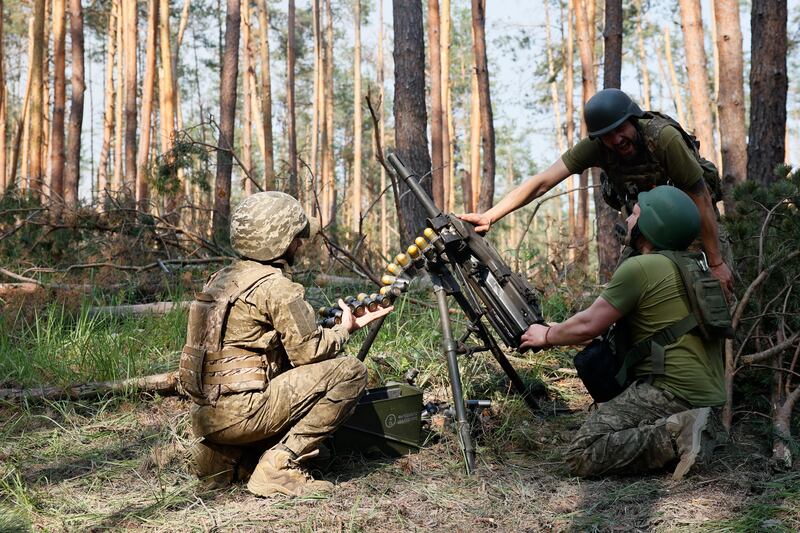 Ukrainian soldiers fire a grenade launcher towards Russian positions on the front line near Kreminna, Luhansk region. AP