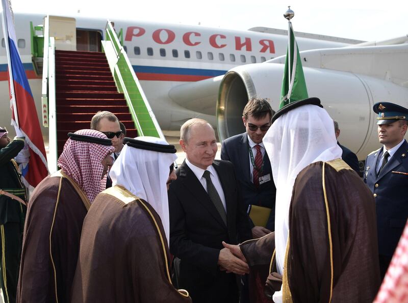 Russian President Vladimir Putin, centre, is welcomed on arrival in Riyadh, Saudi Arabia.  EPA