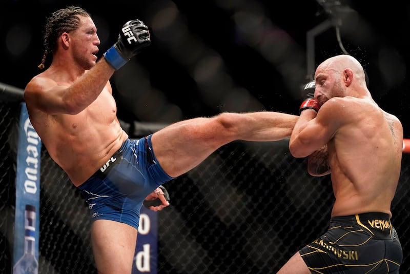 Brian Ortega, left, throws a kick against Alexander Volkanovski. AP Photo